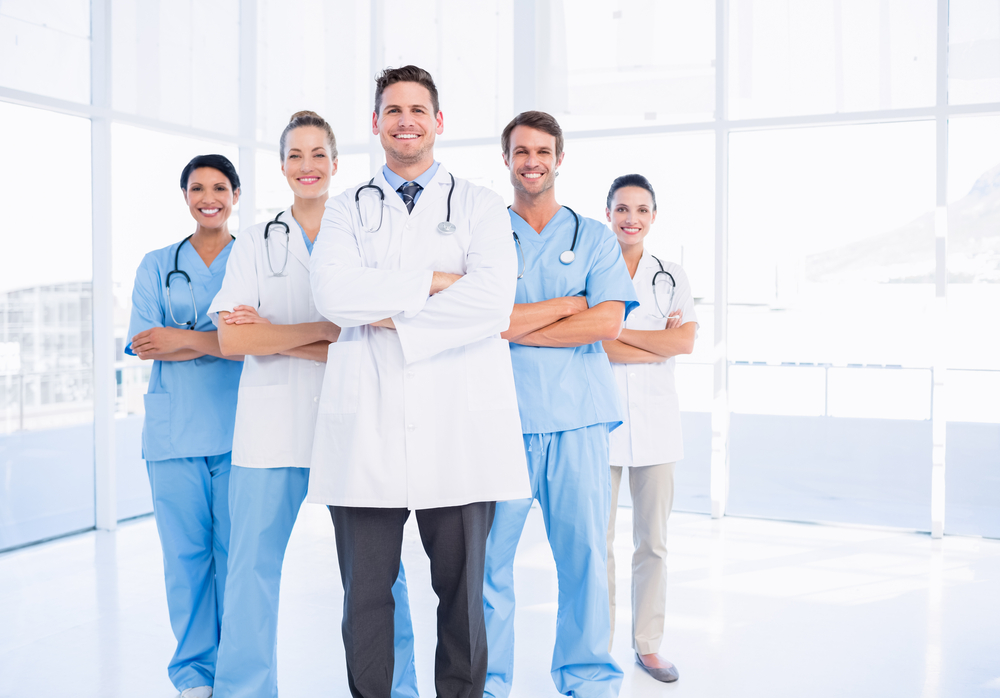 Portrait of confident happy group of doctors standing at the medical office